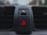 a close up of a car's air vent with a red triangle on it
