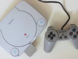 Close-up view of a retro Sony PlayStation One console with controller, ideal for game nostalgia enthusiasts.