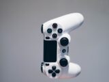 white Sony PS4 DualShock controller over person's palm