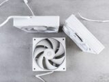 Three white computer fans on a gray surface