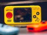 a yellow gameboy sitting on top of a table