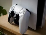 White game controller resting on a console