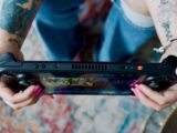 A woman holding a video game controller in her hands