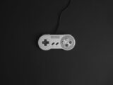 Super Nintendo game controller on a black background, vintage gaming theme.