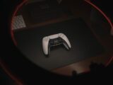 white game controller on black table
