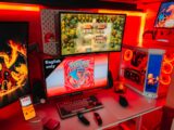Gaming setup with multiple screens and red lighting.