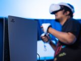 A man is playing a video game on a laptop