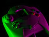 purple game controller on black surface