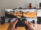 person holding black game controller