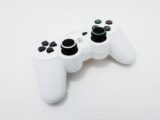 Close-up of a white gaming controller, ideal for PlayStation console enthusiasts.