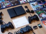black sony ps 4 game controller on brown wooden table
