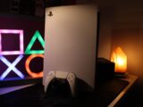a video game console next to a neon sign