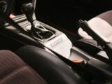 Close-up of a car's interior gear shift and handbrake