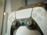 A detailed view of a gaming controller highlighting its buttons and LED light, perfect for gaming enthusiasts.