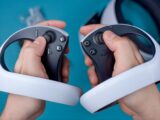 a person holding a video game controller in their hands