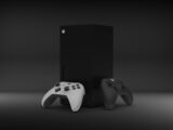 two video game controllers sitting next to each other