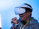 A man wearing a helmet and holding a video game controller