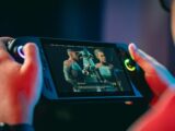 Person playing a video game on a handheld device