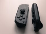 A close-up image of two Nintendo Switch Joy-Con controllers on a neutral background.