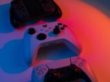 two video game controllers sitting next to each other
