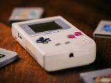 a nintendo game boy sitting on a table next to other games