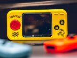 Colorful close-up of a Pac-Man themed My Arcade Pocket Player. Perfect for retro gaming enthusiasts.
