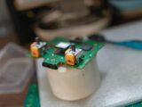 Detailed view of a green circuit board with electronic components.