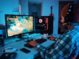 a person wearing headphones and using a computer