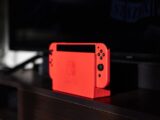 red nintendo switch on black table