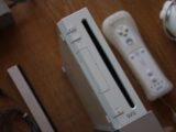 a nintendo wii game system sitting on top of a wooden table