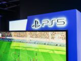 PS5 gaming station featuring a live soccer match onscreen, showcasing high-quality graphics.