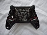 black game controller on white textile