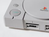 Close-up view of a classic PlayStation gaming console from the 90s, showcasing its iconic design.