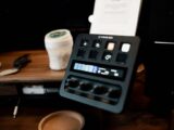 A Stream Deck on a wooden desk, featuring various buttons and controls in a home studio setup.