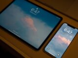 Close-up of a tablet and smartphone with matching lock screen displays at 6:47.