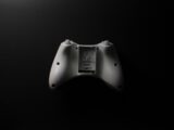 a white controller sitting on top of a black table