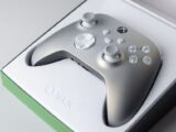 A high-quality close-up of an Xbox game controller in its packaging box, ready for gaming.