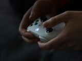 a person holding a video game controller in their hands