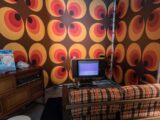 black laptop computer on brown wooden desk