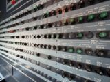 Detailed view of an airplane avionics control panel featuring numerous switches and indicators.