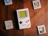 a nintendo game boy sitting on top of a wooden table