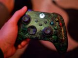 a close up of a person holding a controller