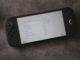 A handheld console displays language options
